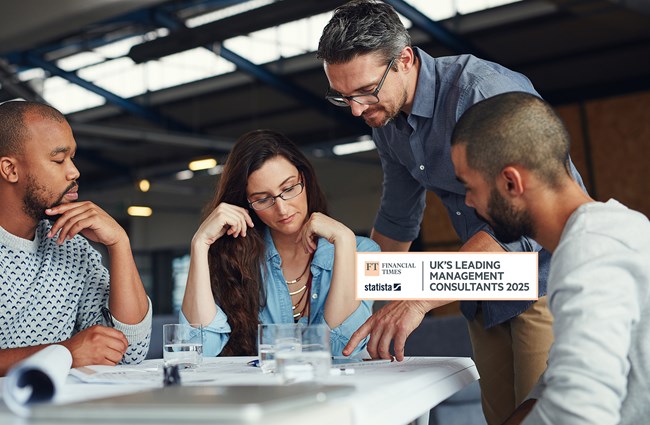 A diverse group of men and women working around a table.