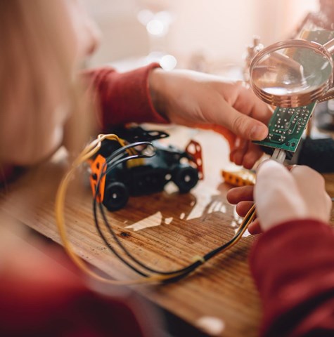 Children taking part in a STEM project and putting together a circuit board with lego