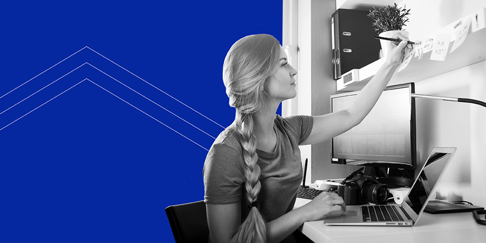 woman with braided ponytail working at her desk looking for a refresher on home office write-offs