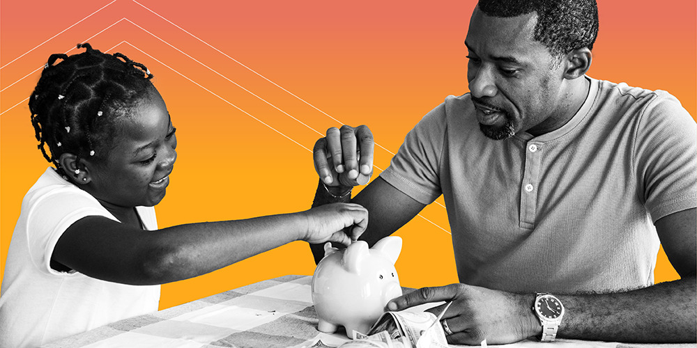 father and daughter putting coins into a piggybank