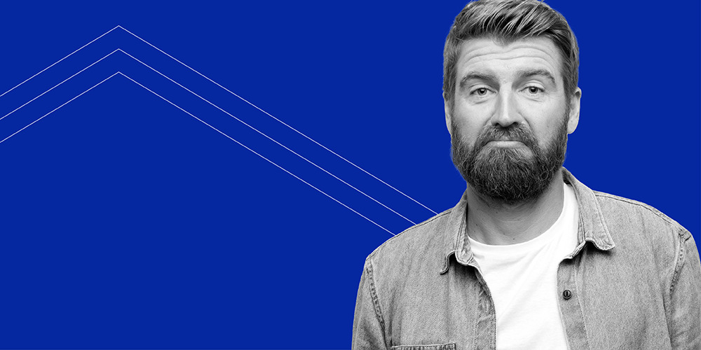 closeup of man with beard wearing denim shirt