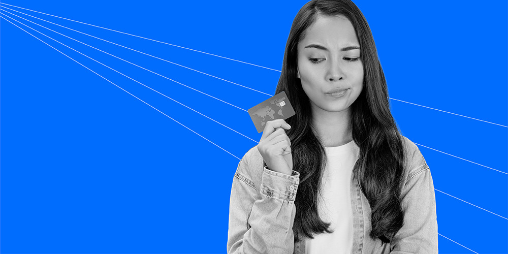 young woman with long hair holding a credit card