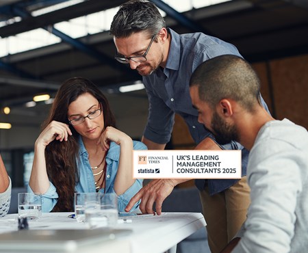 A diverse group of men and women working around a table.