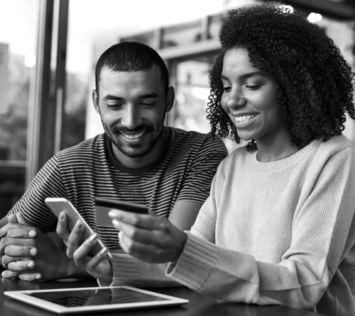 woman holding phone and credit card