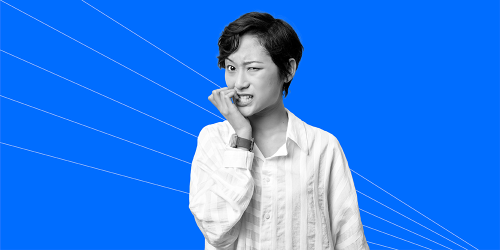 woman biting her nails after hearing 4 scary financial facts