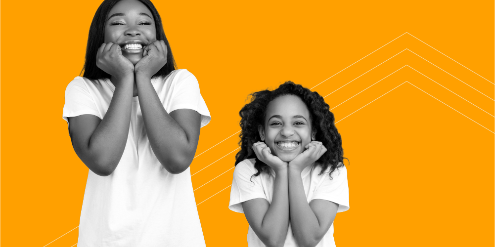 mother and daughter wearing matching white shirts with their hands under their chins smiling