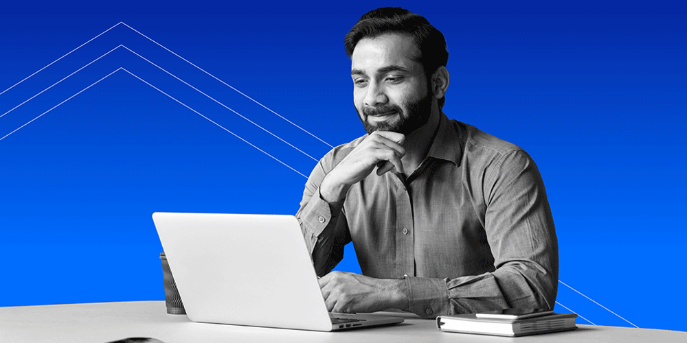 Gentleman sitting at a computer with his hand under his chin